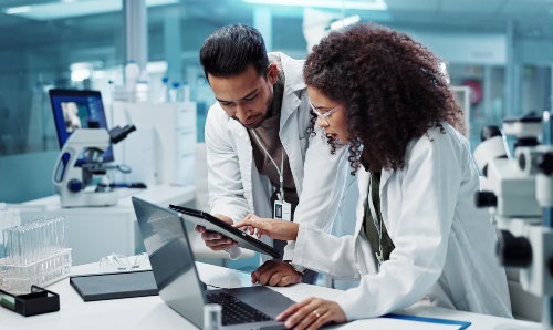 Male and female scientists collaborating on a project in the lab